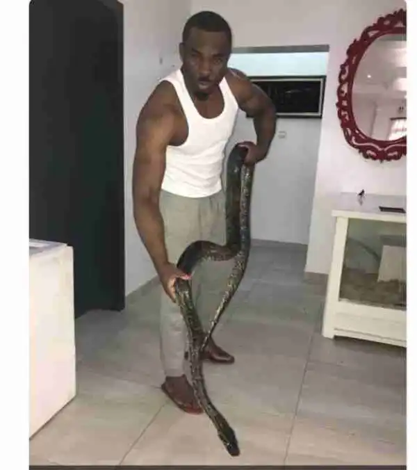 Lagos Club Owner & Socialite, Pretty Mike Feeds His Pet Snake 